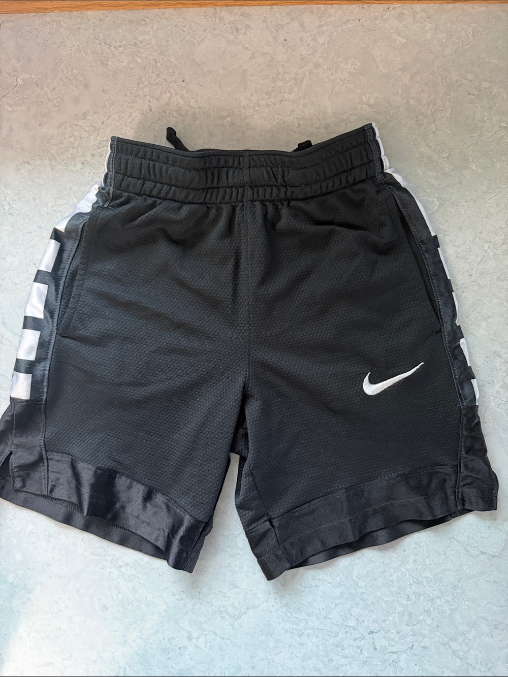 Nike Kids Black Athletic Shorts with White Swoosh and Side Stripe
